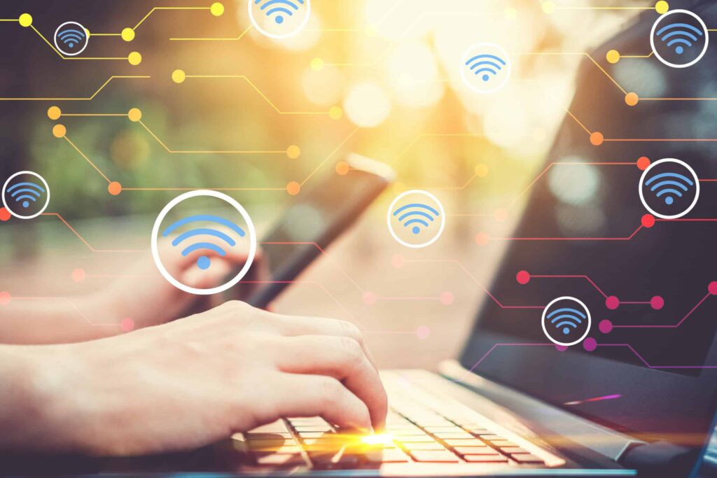 Business professional interacting with digital icons representing internet connectivity and wireless network signals, with a tablet and global map in the background.